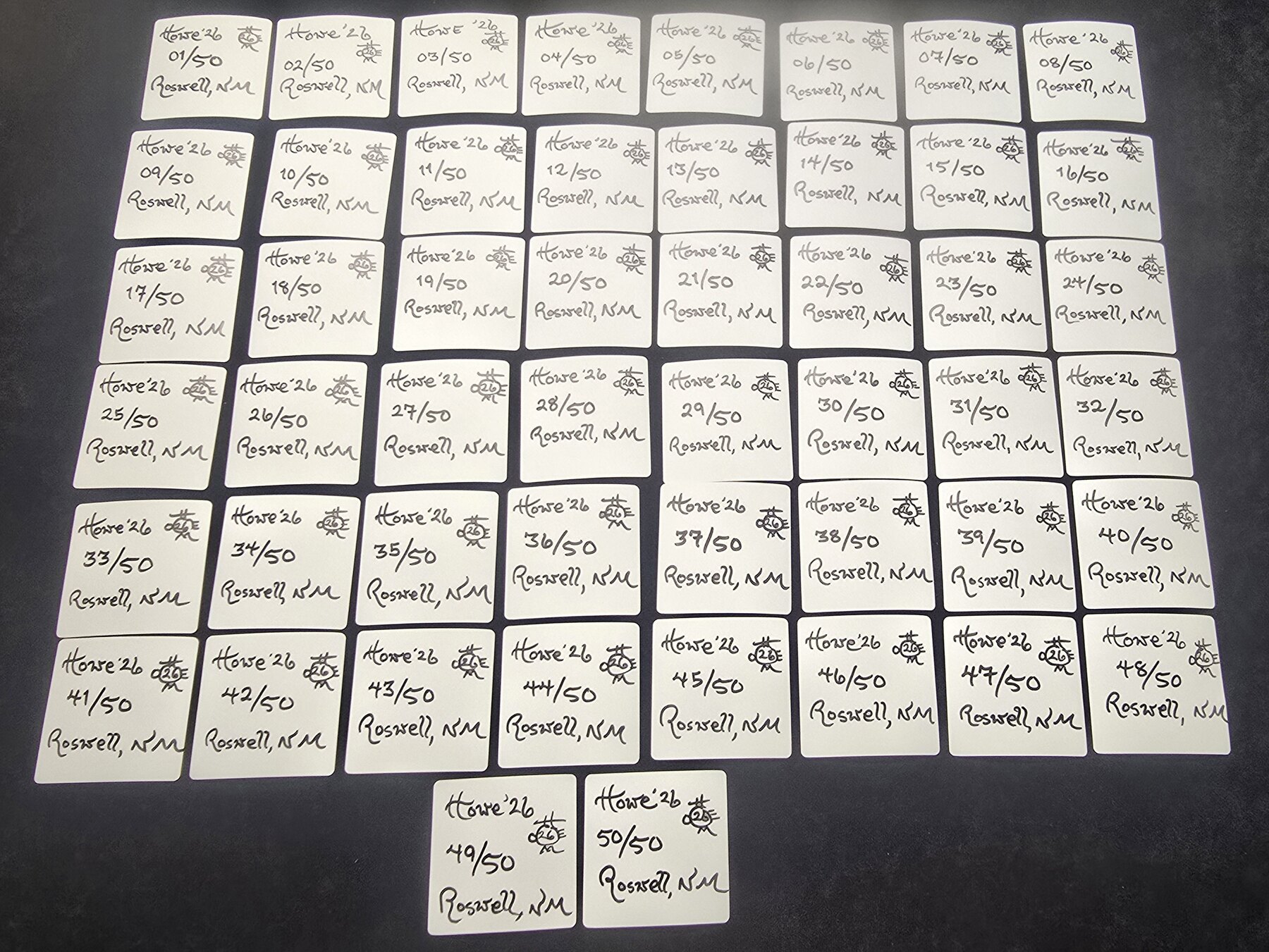 The numbered backs of RoswellCoin stickers 02/50 through 50/50 arranged together