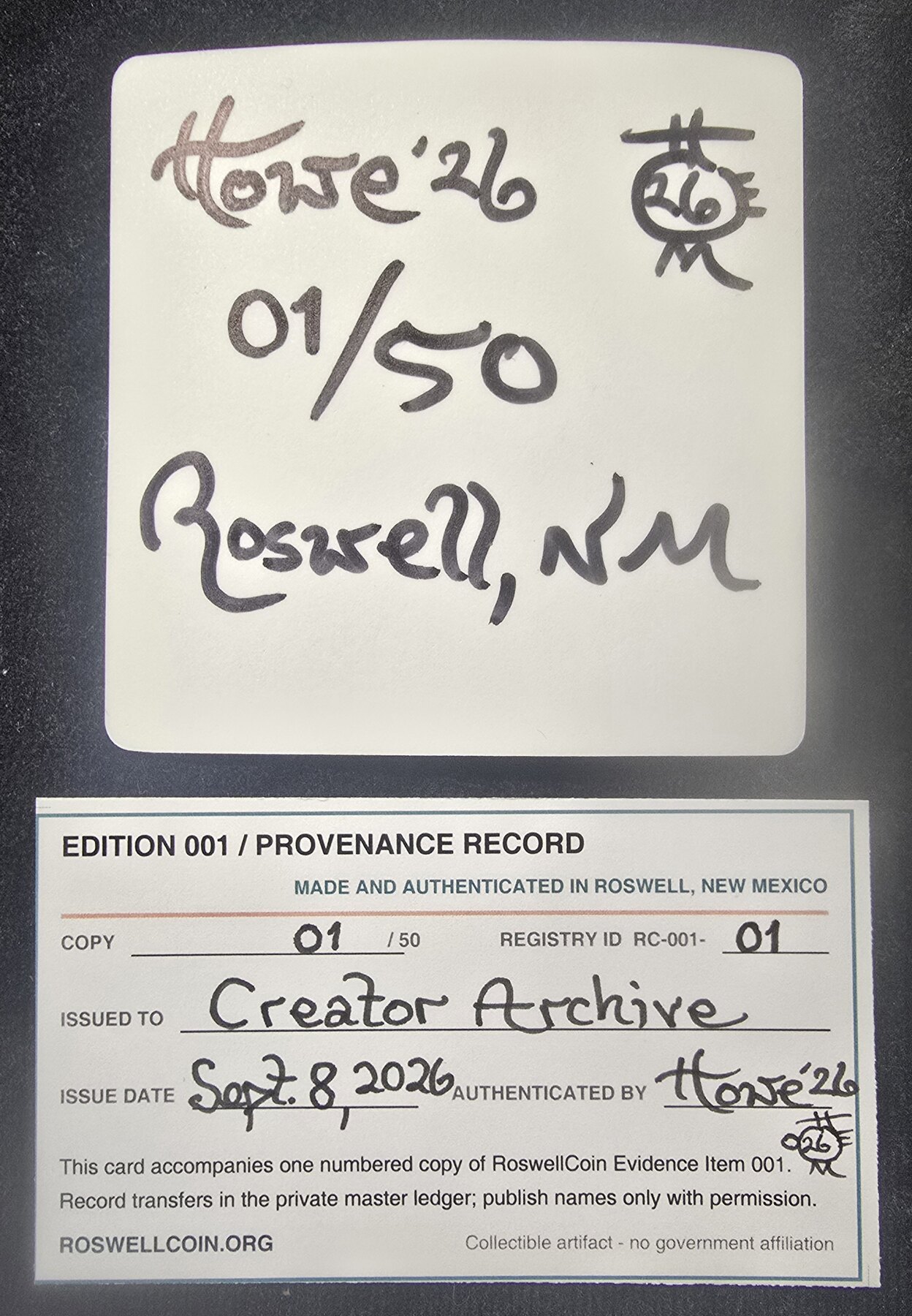 Signed back of RoswellCoin sticker 01/50 beside its completed Creator Archive provenance record